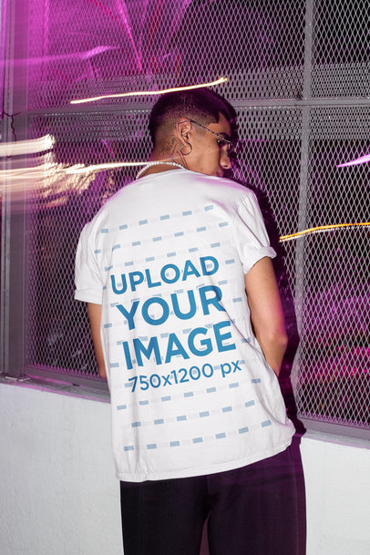 T-Shirt Mockup of the Back of a Man Standing by a Metallic Fence m584