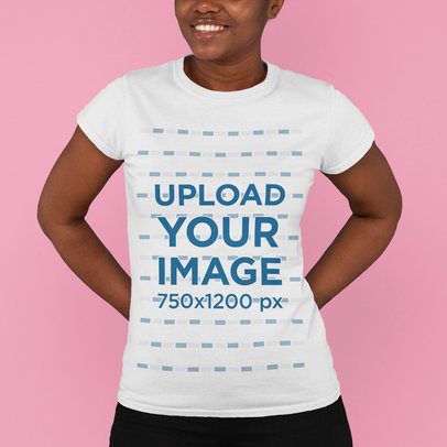 T-Shirt Mockup Featuring a Happy Young Woman With a Basic T-Shirt at a Studio