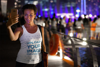 Tank Top Mockup of an Elderly Woman Taking a Selfie at Night
