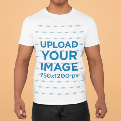 Mockup of a Young Man Wearing a T-Shirt with a Simple Backdrop