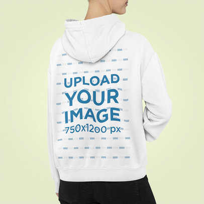 Back View Mockup of a Woman Wearing a Customizable Hoodie at a Studio