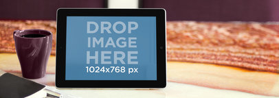 Wide Mockup of an iPad in Landscape Position Placed on a Marble Table