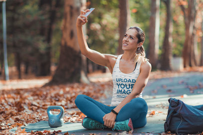 Tank Top Mockup of a Woman Taking a Selfie After a Workout Session at a Park