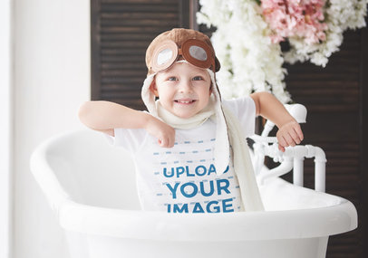 T-Shirt Mockup Featuring a Boy With Aviator Goggles Playing in a Bathtub 