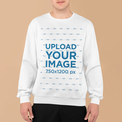 Sweatshirt Mockup Featuring a Young Man Standing in Front of a Plain Backdrop