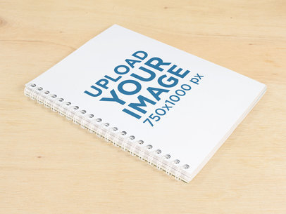 Spiral Notebook Template Lying on a Wooden Surface