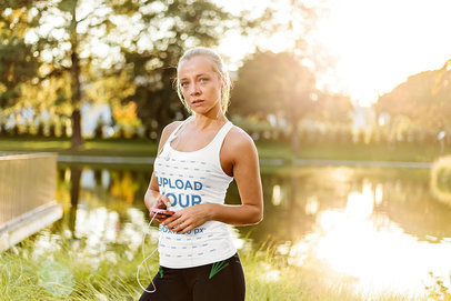 Tank Top Mockup of a Serious Woman Standing by a Pond 