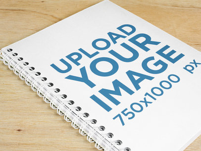 Spiral Notebook Template Lying on a Wooden Table