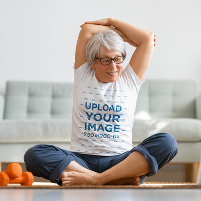 T-Shirt Mockup of a Senior Woman Stretching Her Shoulders