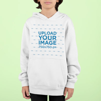 Pullover Hoodie Mockup Featuring a Kid Standing Against a Customizable Background 