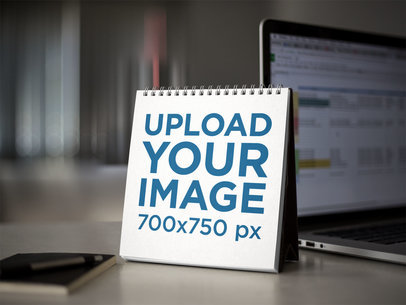 Spiral Calendar Template Standing Near a Laptop