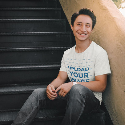 T-Shirt Mockup of a Happy Man Sitting on Some Steps 45635-r-el2