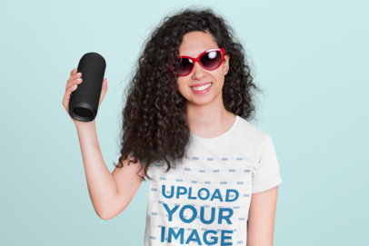 T-Shirt Mockup Featuring a Young Woman with Curly Hair Holding a Speaker 45619-r-el2