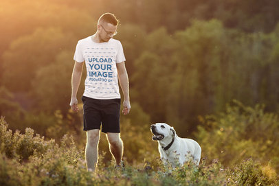 T-Shirt Mockup of a Man Walking His Dog Outdoors