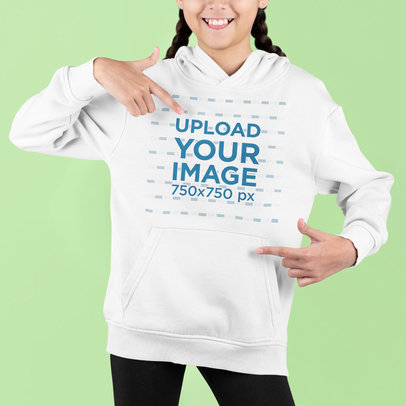 Studio Mockup Featuring a Girl Pointing at Her Hoodie