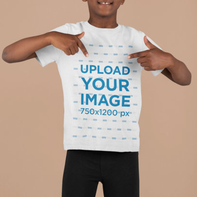  Mockup of a Boy at a Studio Pointing at His Customizable T-Shirt m855