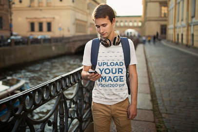 T-Shirt Mockup of a Young Man Checking His Phone in the Street 45596-r-el2