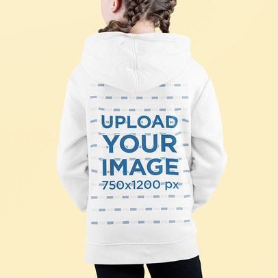 Back-View Hoodie Mockup Featuring a Girl Standing in a Studio