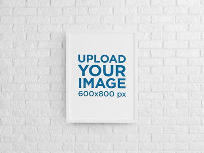 Mockup of a Framed Art Print Hanging on a Brick Wall 
