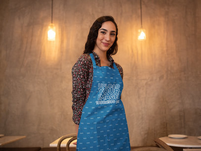 Apron Mockup Featuring a Woman Posing at a Restaurant