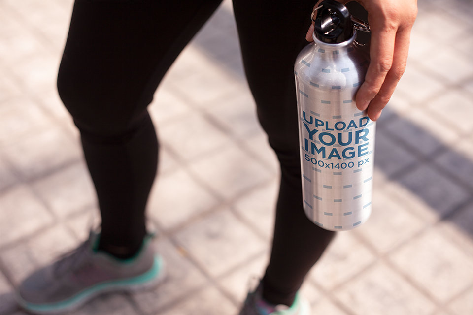 Woman Holding an Aluminum Water Bottle Template in Her Hand While Standing