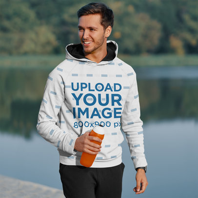 Mockup of a Man with a Pullover Hoodie Rehydrating Himself