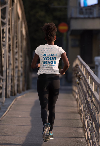 Activewear T-Shirt Mockup of a Woman Running by a Bridge