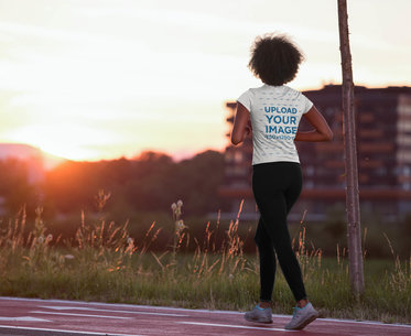 Back View T-Shirt Mockup of a Woman Walking on a Running Track 