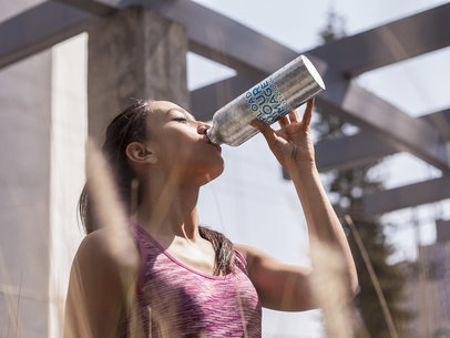 Young Woman Drinking Water from an Aluminum Bottle Template