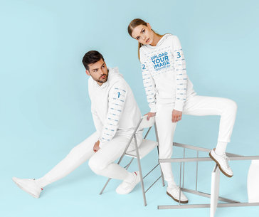 Mockup of a Couple Wearing Pullover Hoodies with Customizable Sleeves