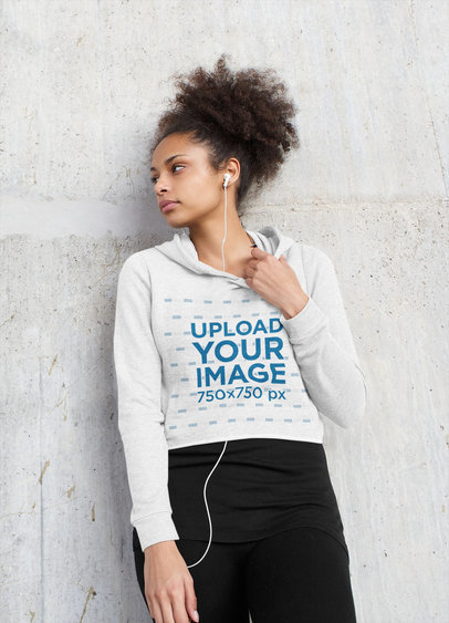 Crop Top Hoodie Mockup of a Serious Woman Listening to Music 