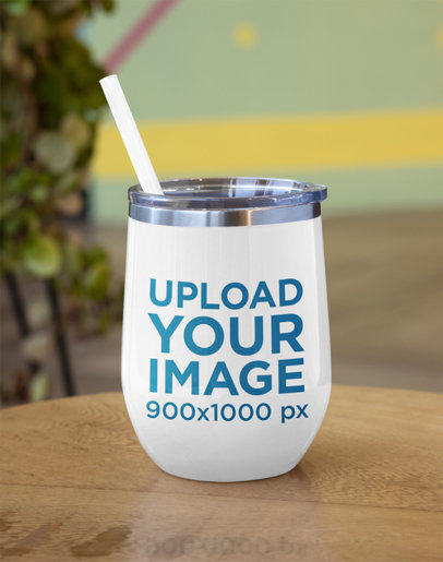 Mockup of a Wine Tumbler on a Wooden Table