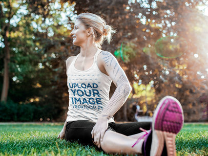 Tank Top Mockup of an Athlete Stretching Up on the Grass 40792-r-el2