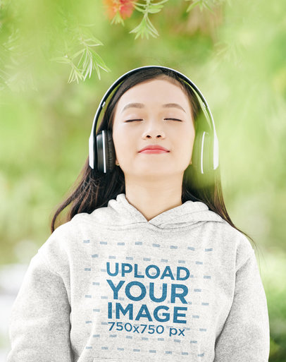 Hoodie Mockup of a Woman Relaxing Listening to Music