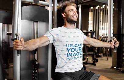 T-Shirt Mockup Featuring a Man Training His Chest at a Gym 