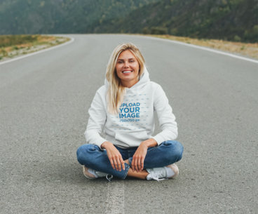 Hoodie Mockup Featuring a Woman Sitting on an Empty Road 45627-r-el2