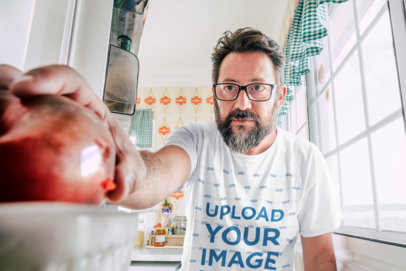 T-Shirt Mockup of a Man Grabbing a Snack from the Refrigerator 