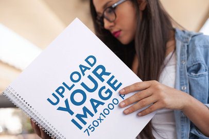 Focused Hispanic Woman Reading a Spiral Notebook Template
