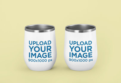 Mockup of Two Wine Tumblers Against a Solid Color Background