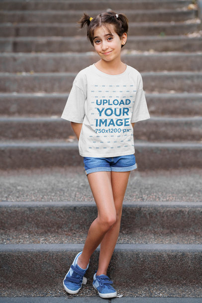 T-Shirt Mockup Featuring a Girl Posing by a Staircase 