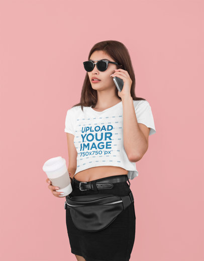 Crop Top Tee Mockup of a Stylish Woman with Sunglasses Talking on the Phone