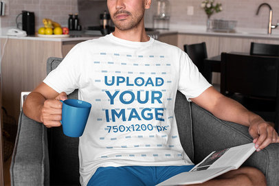 T-Shirt Mockup of a Man Drinking Coffee at Home 