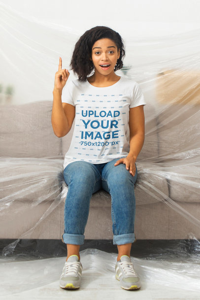 T-Shirt Mockup of a Woman Sitting on a Covered Couch