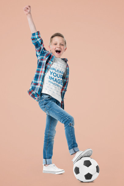 T-Shirt Mockup of a Boy Playing With a Soccer Ball at a Studio