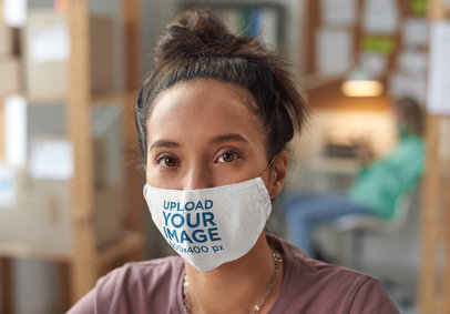 Face Mask Mockup Featuring a Serious Young Woman With a Hair Bun 