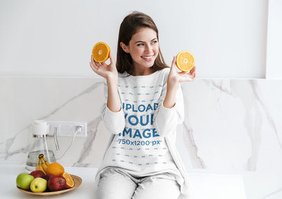 Sweatshirt Mockup of a Happy Woman Holding a Sliced Orange