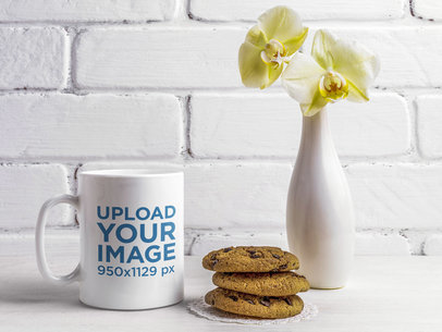 11 oz Coffee Mug Mockup Featuring a Vase With Orchids and Some Cookies 