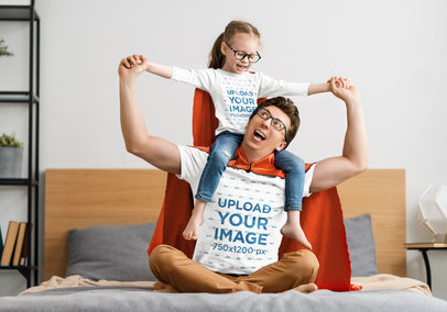 T-Shirt Mockup Featuring a Father Playing Superheroes with His Daughter