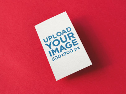 Vertical Business Card Mockup Floating Over a Red Surface