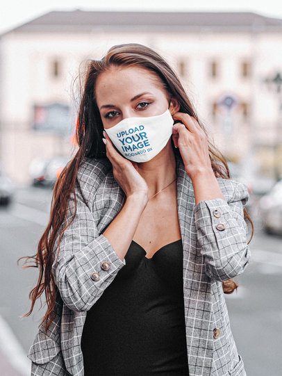 Mockup of a Woman Posing with a Face Mask by the Street